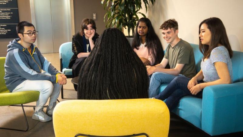 student sitting chatting in a group